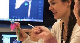 A teacher is teaching the student by showing a 3d printed lungs