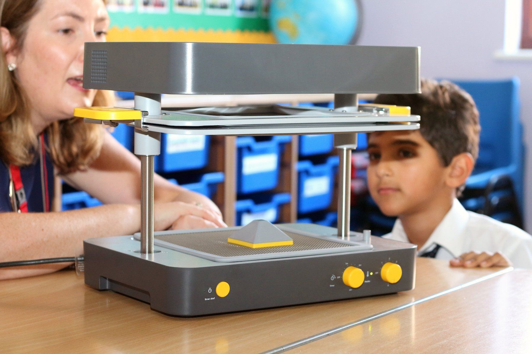 Teacher teaching the student on how to Mayku Formbox thermoforming