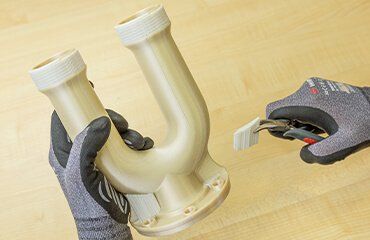 an engineer removing breakaway support form a ultem part