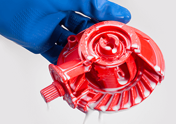 Engineer cleaning a red colour mechanical part