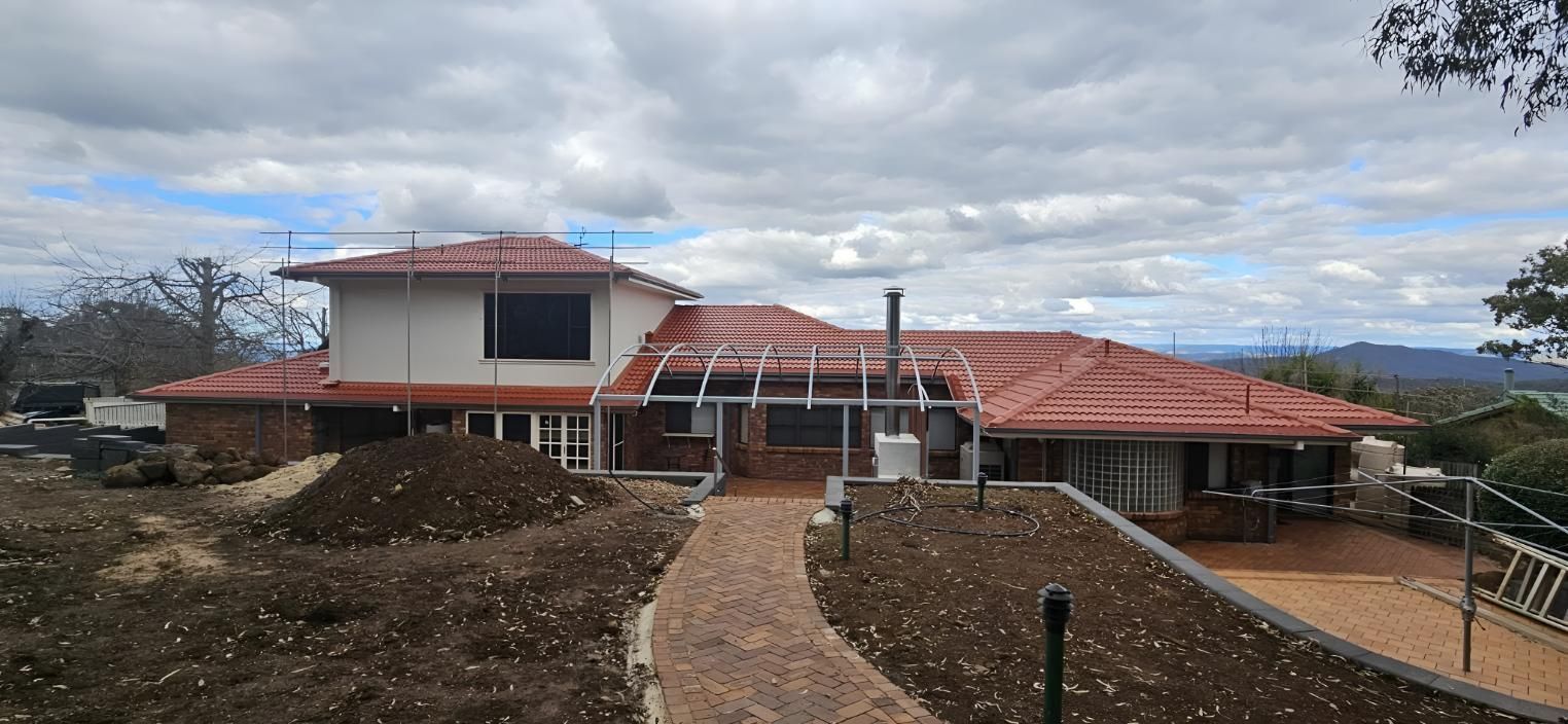 Large House With a Red Tiled Roof is Being Restore — Steve Oberhardt Roof Restorations & Repairs in Westbrook, QLD