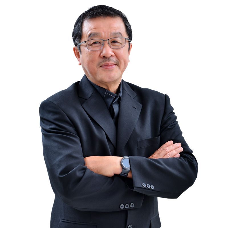 A man in a suit and tie with his arms crossed