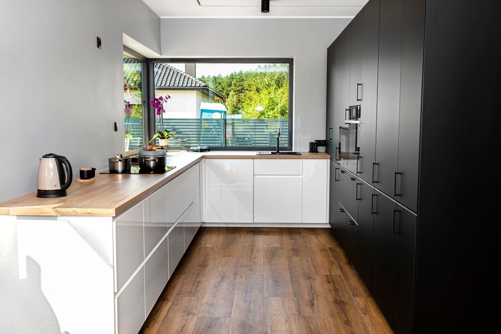 Modern Kitchen With White and Black Cabinets — Morrison Cabinetry in Noosa, QLD