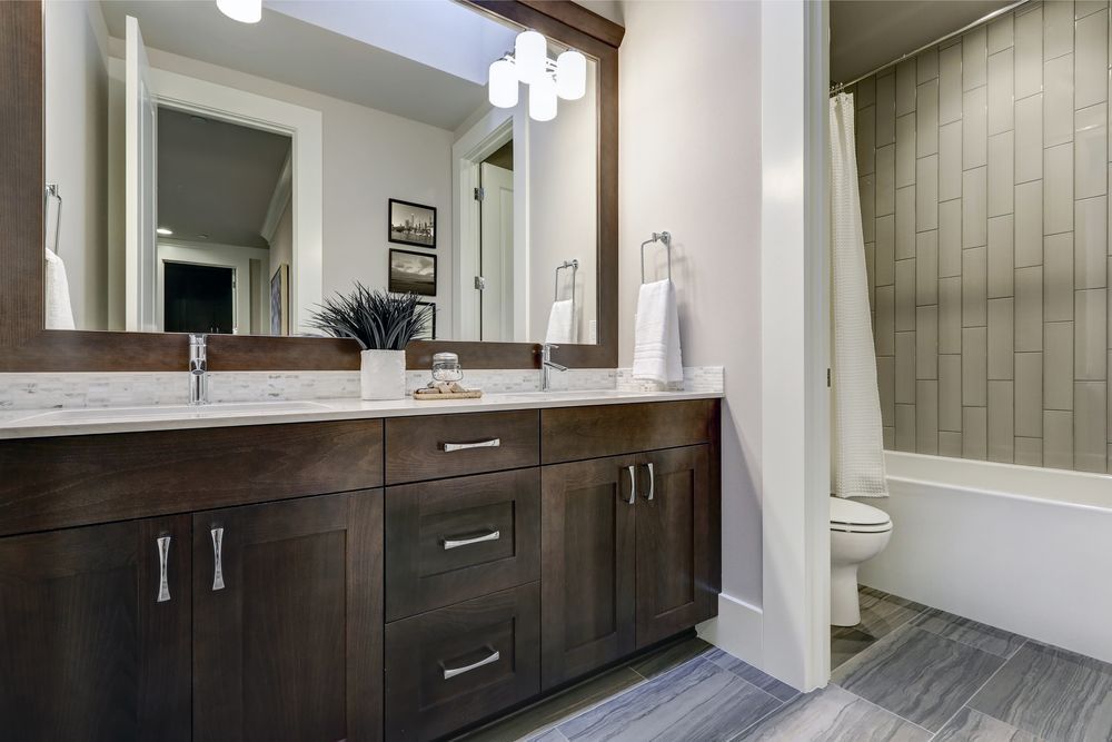 Modern Bathroom With Dark Wood Vanity, White Countertop, and Grey Wood-look Tile — Morrison Cabinetry in Tin Can Bay, QLD
