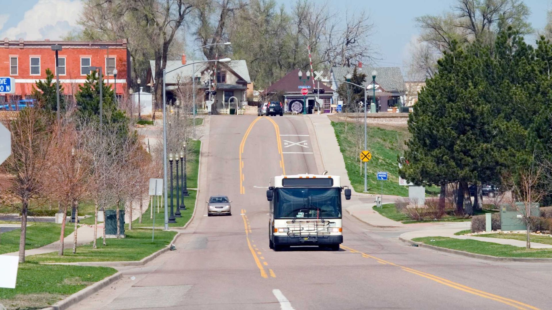 A bus is driving down a street in a small town