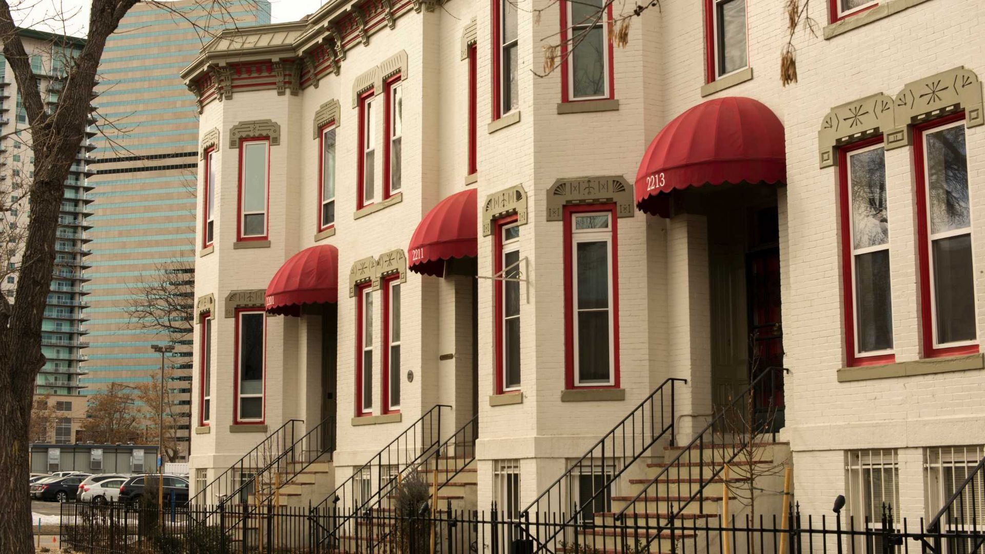 A row of houses with red awnings on the front of them