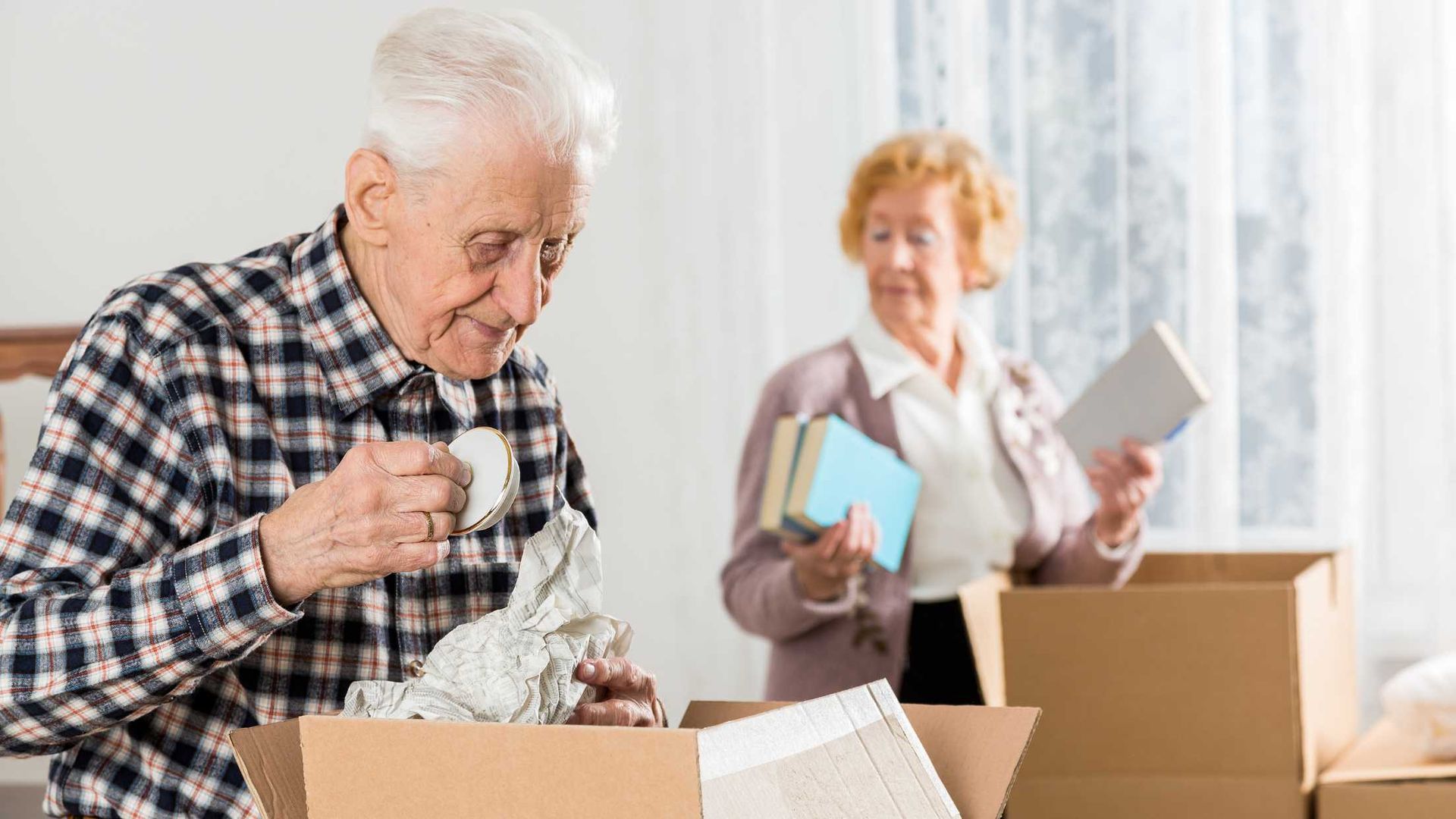 An elderly couple is moving into a new home.