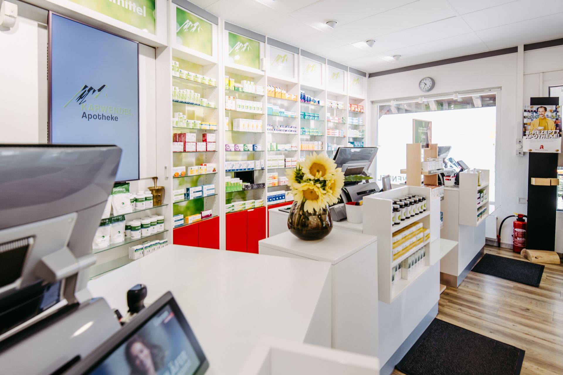 Das Innere einer Apotheke mit einer Vase mit Sonnenblumen auf der Theke.