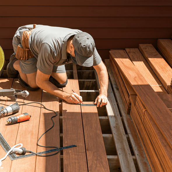 Our team member measures boards to create the exact style a homeowner wants.