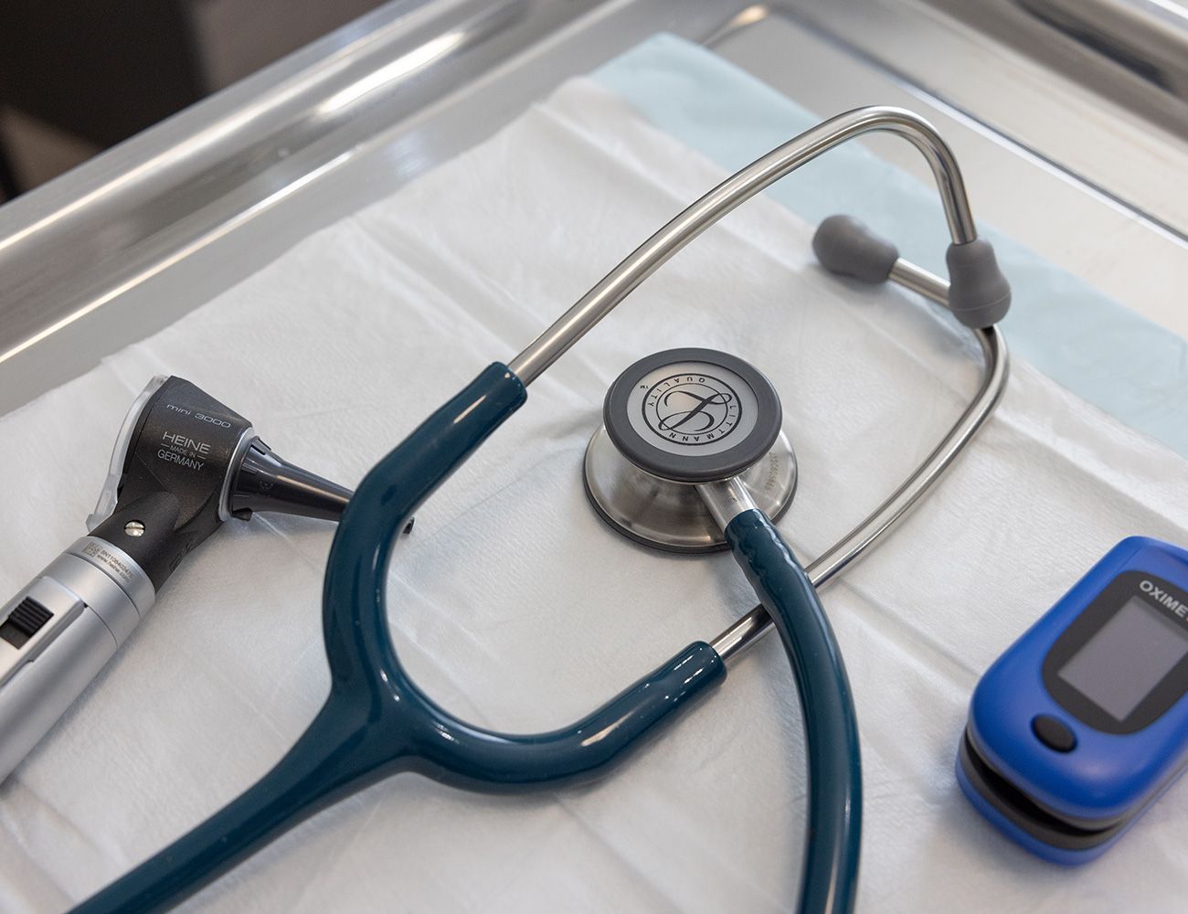 A stethoscope and a pulse oximeter are on a table