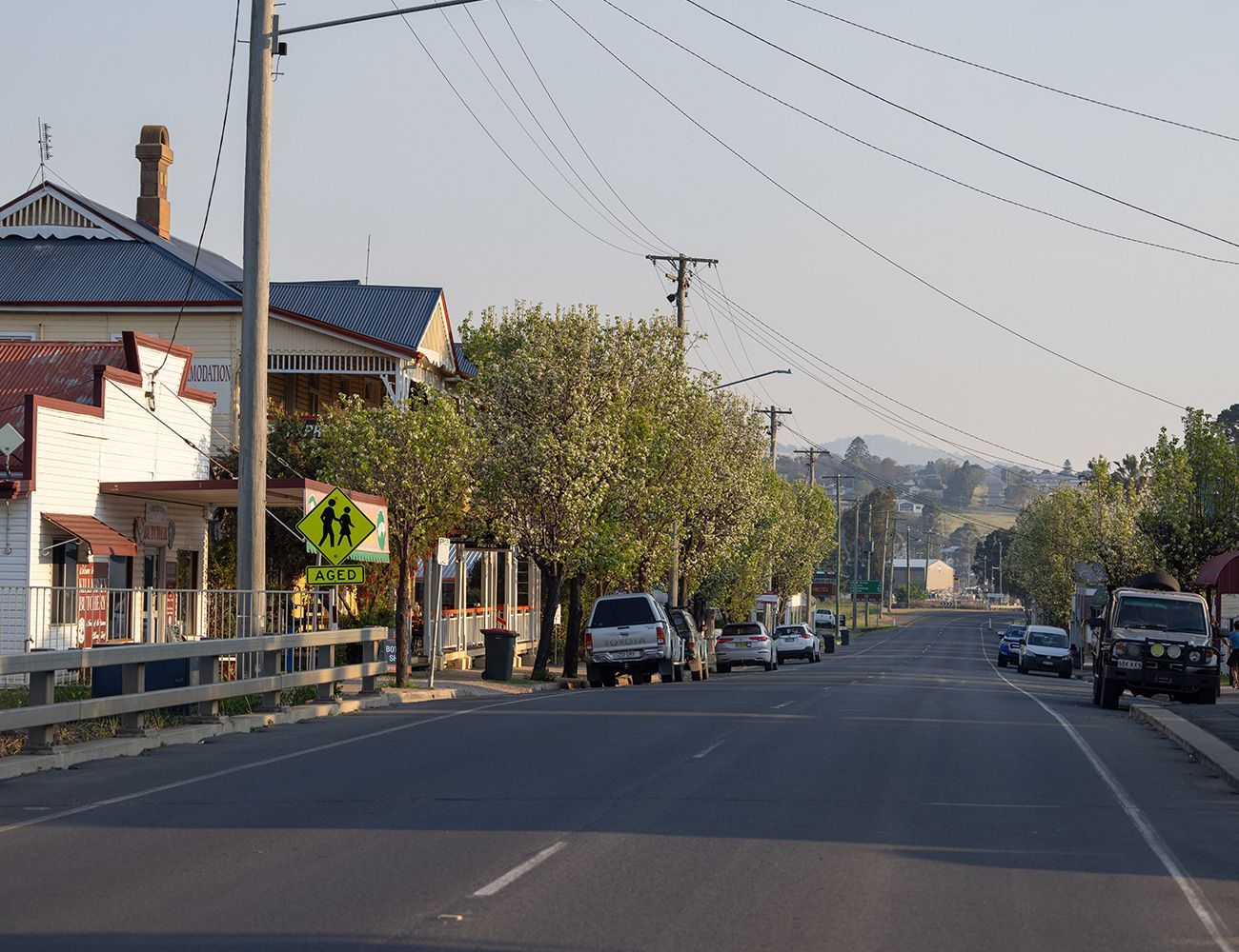 A Killarney street with a school crossing sign on the side of it