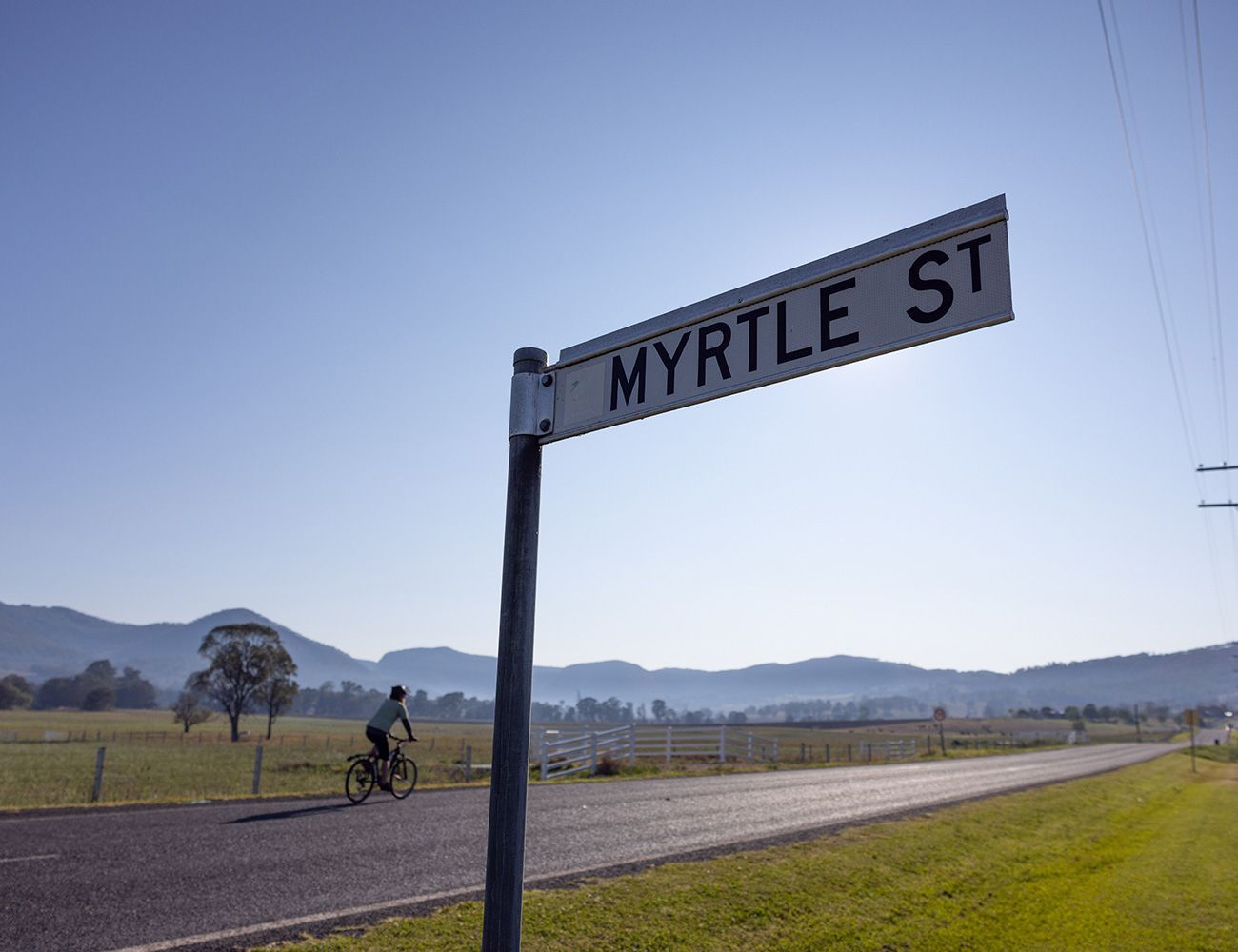 A person is riding a bike down myrtle street