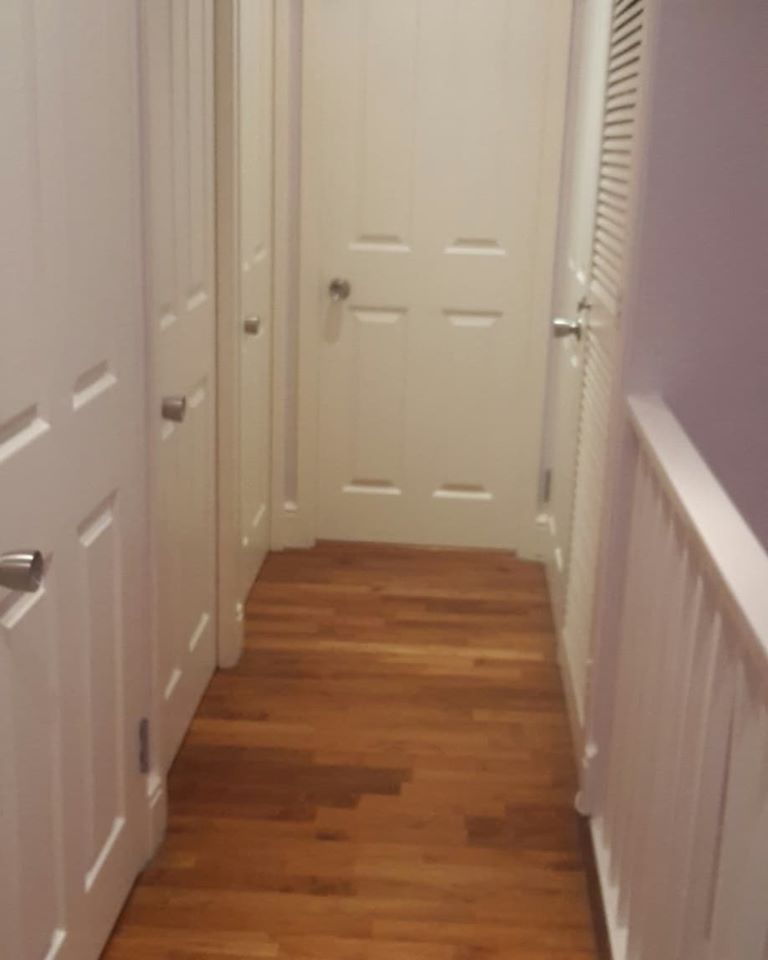 Wooden floor with white walls around