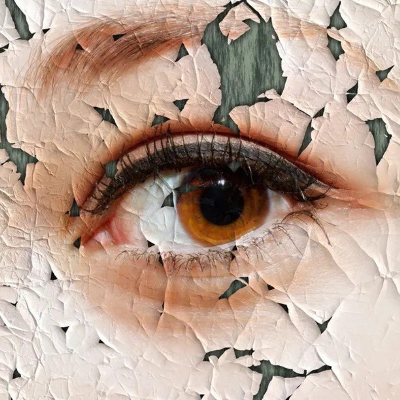 A close up of a woman 's eye with cracked skin