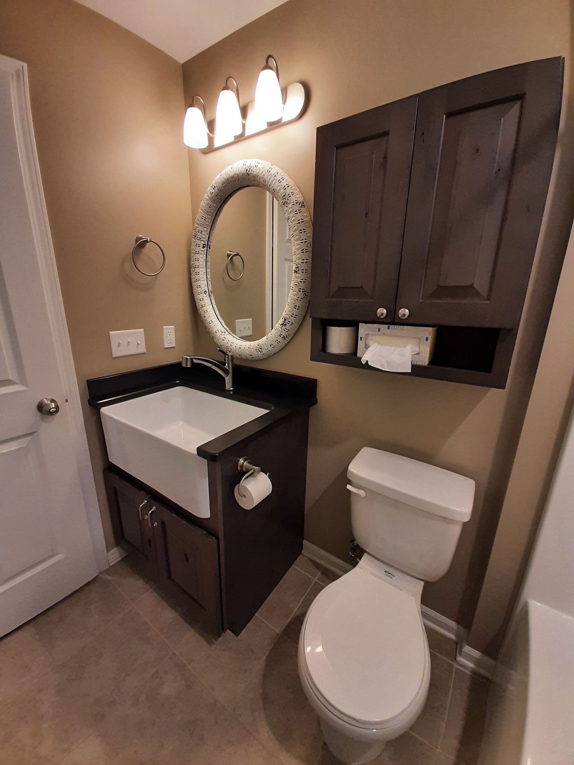 A bathroom with a toilet a sink and a mirror