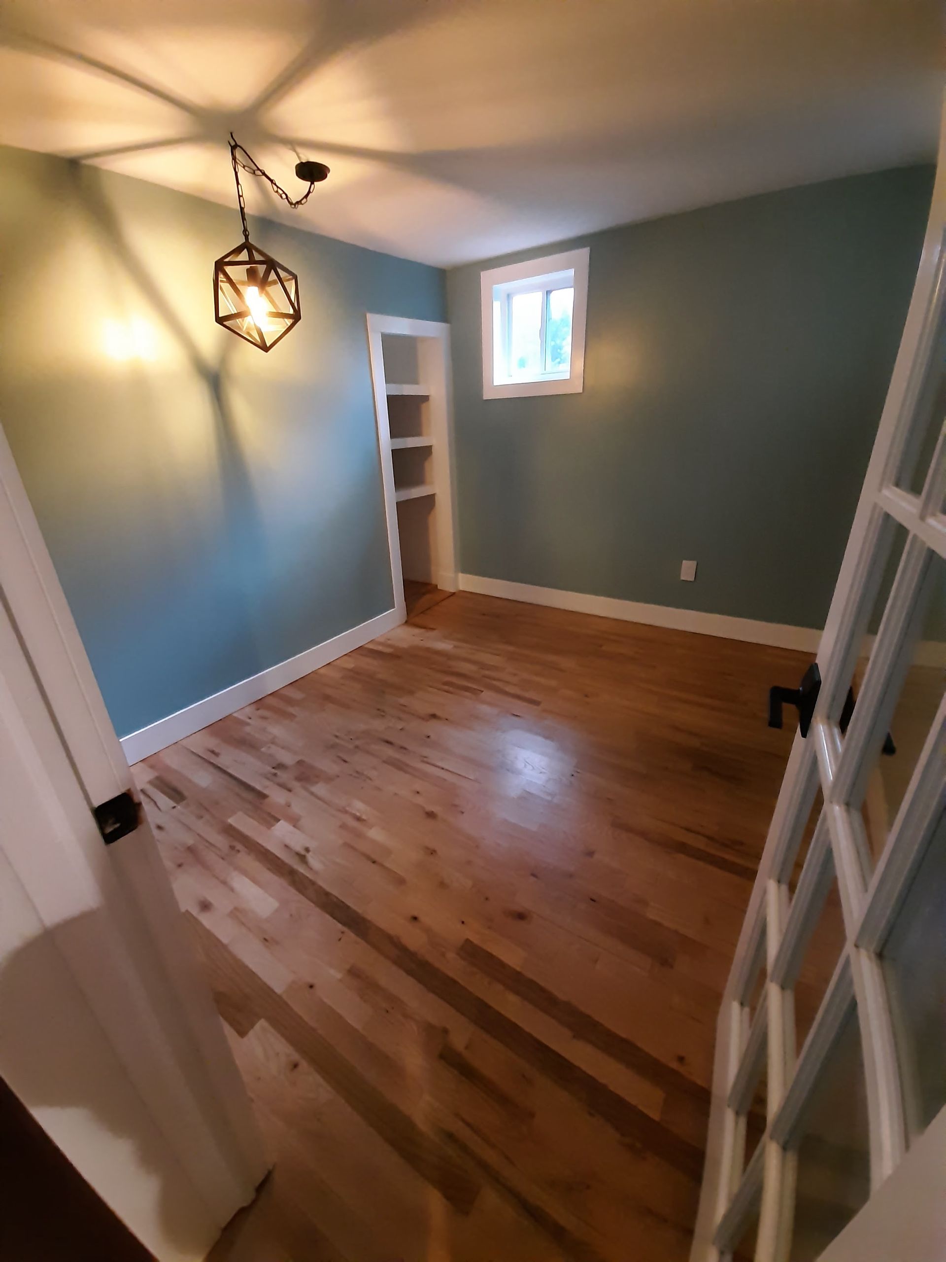 A room with hardwood floors and blue walls.