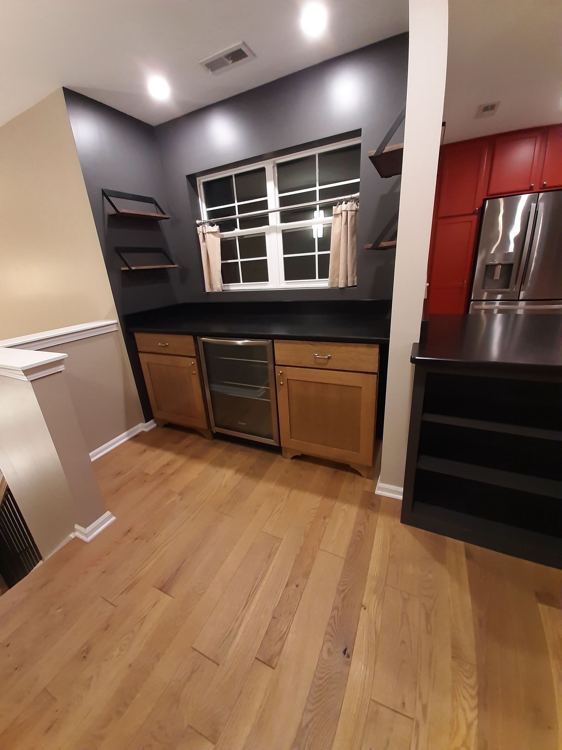 A kitchen with wooden floors and stainless steel appliances