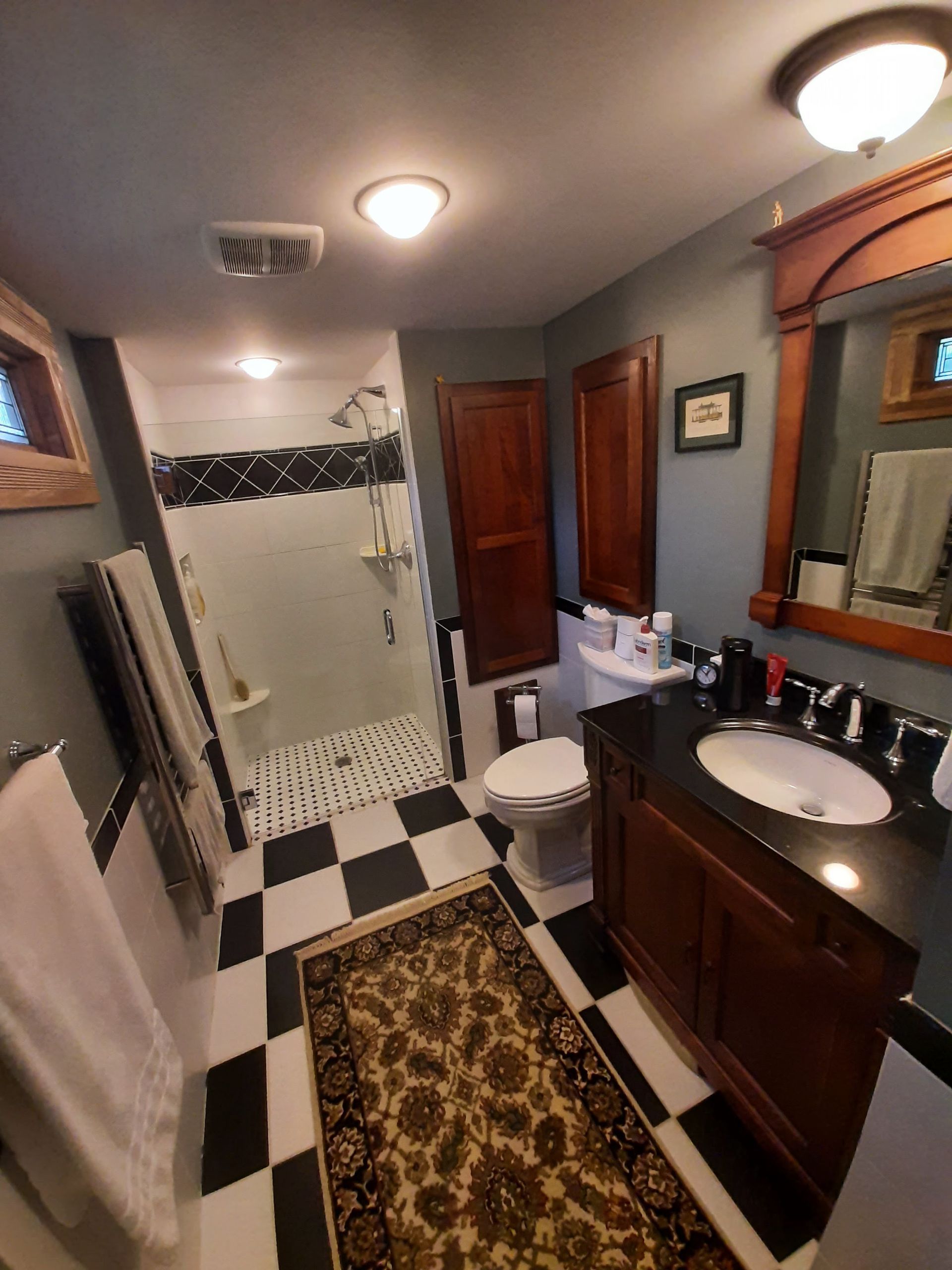 A bathroom with a toilet , sink , and mirror