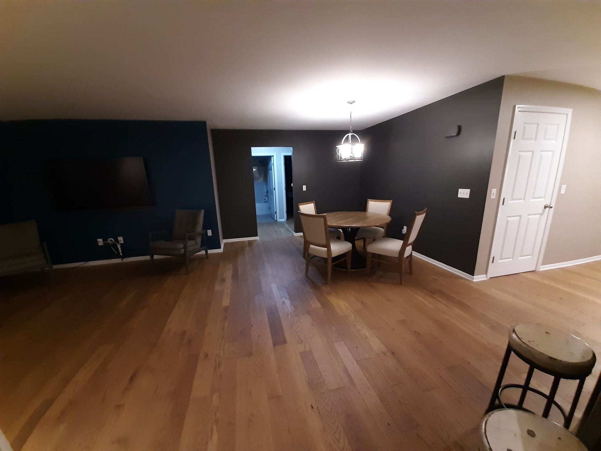 A dining room with a table and chairs in it