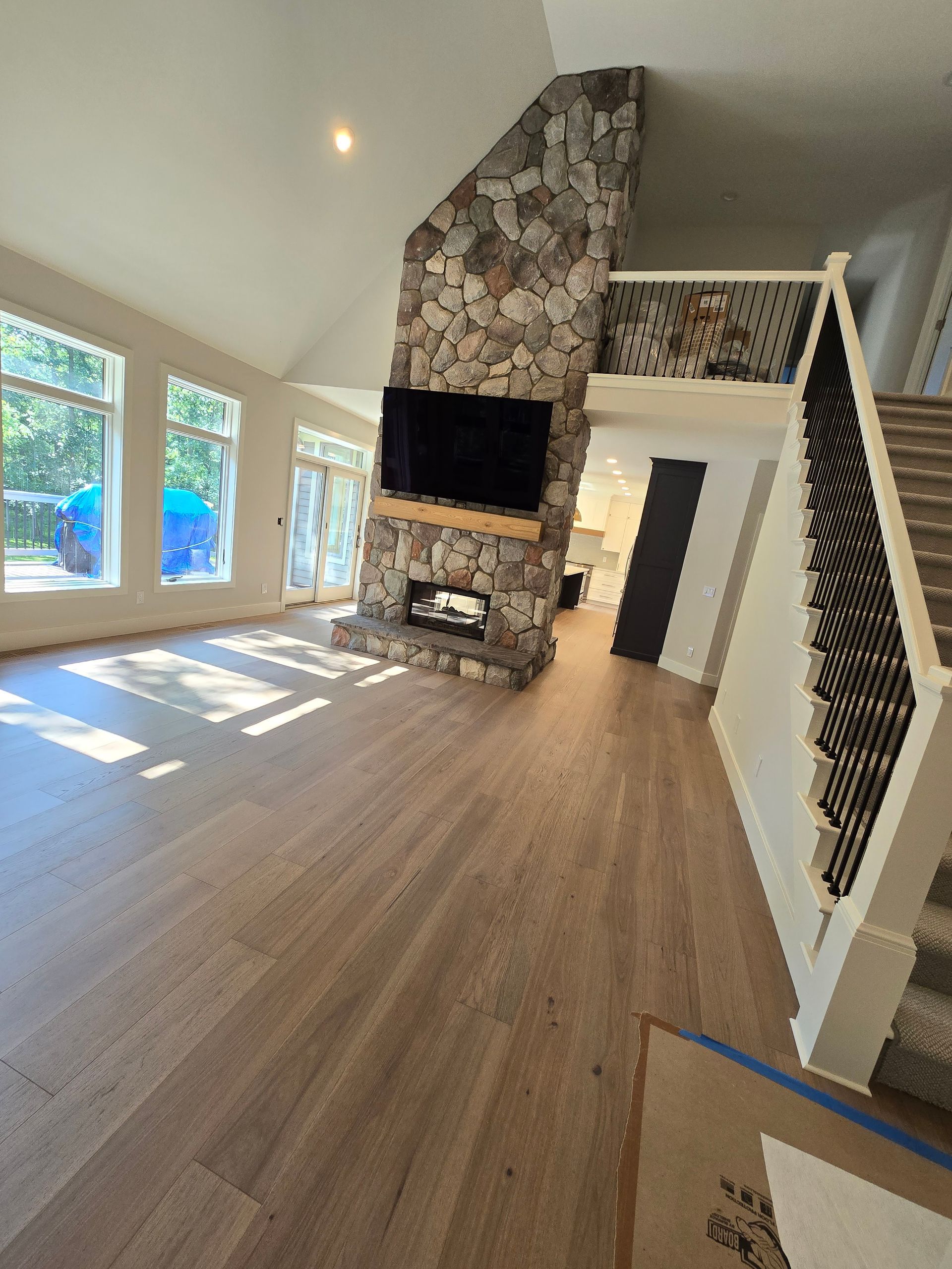 A living room with a fireplace , television , and stairs.