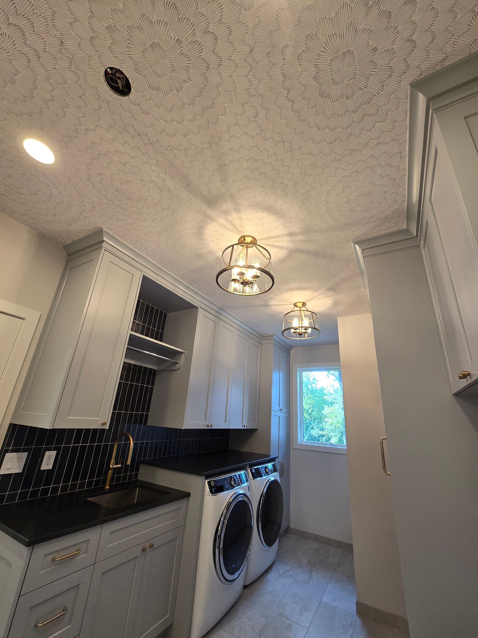 A laundry room with a washer and dryer in it