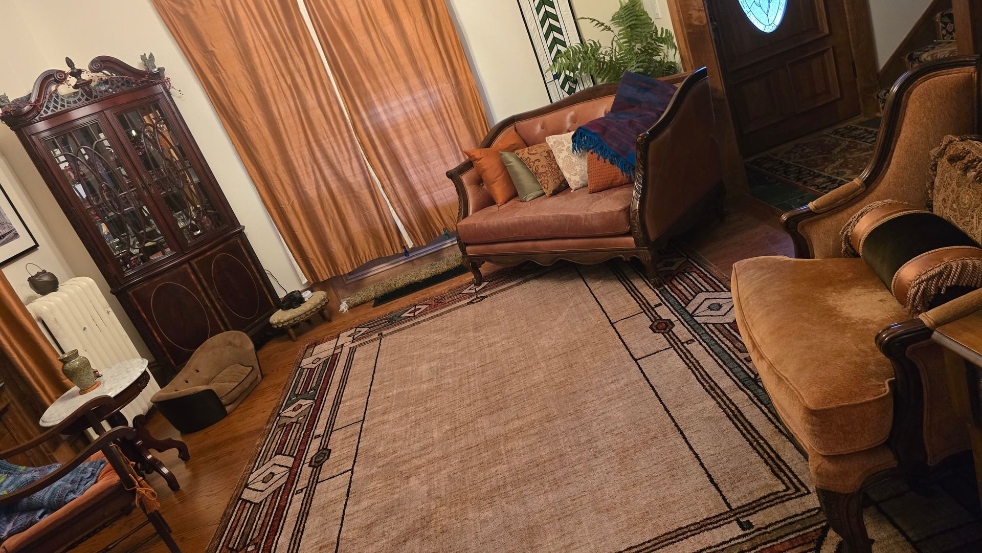 A living room filled with furniture and a rug.