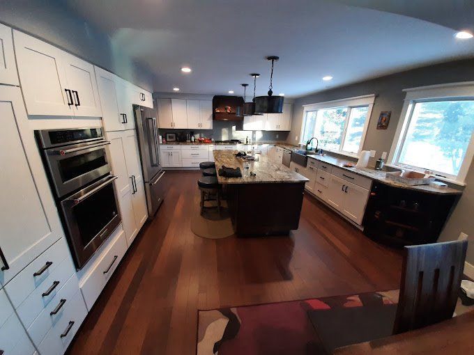 A kitchen with white cabinets and stainless steel appliances
