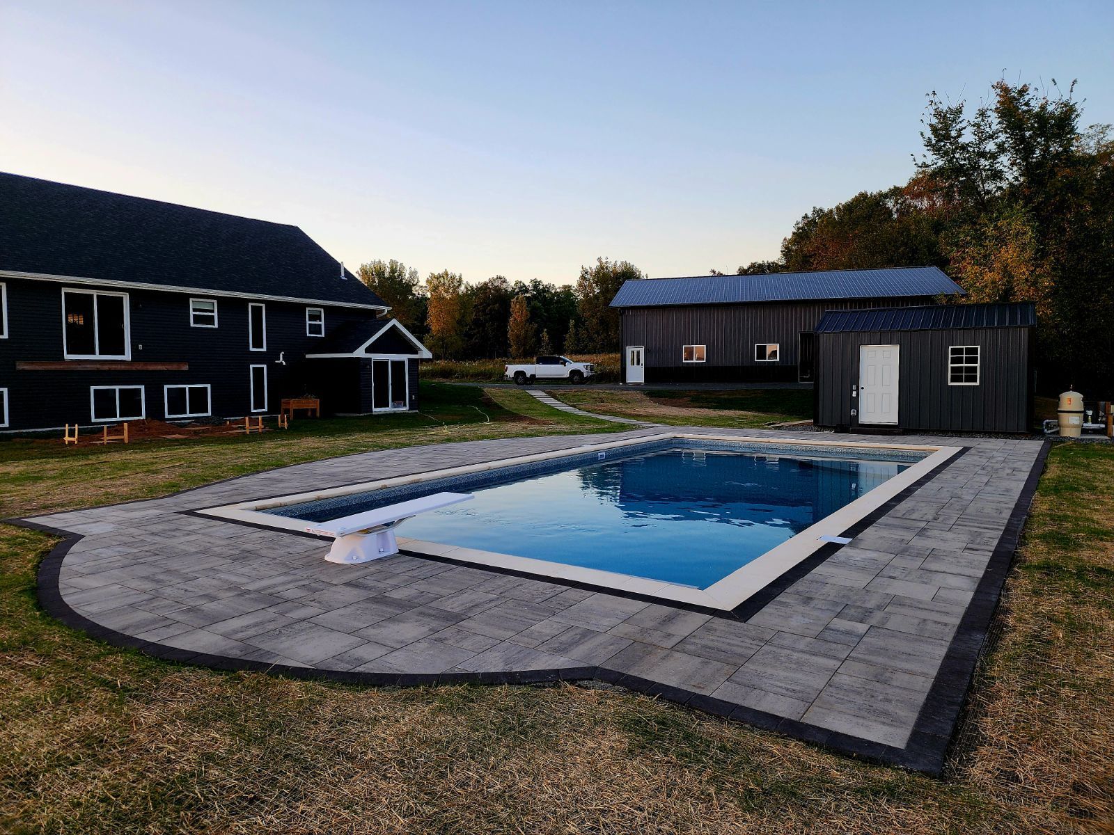 A large house with a large swimming pool in front of it.