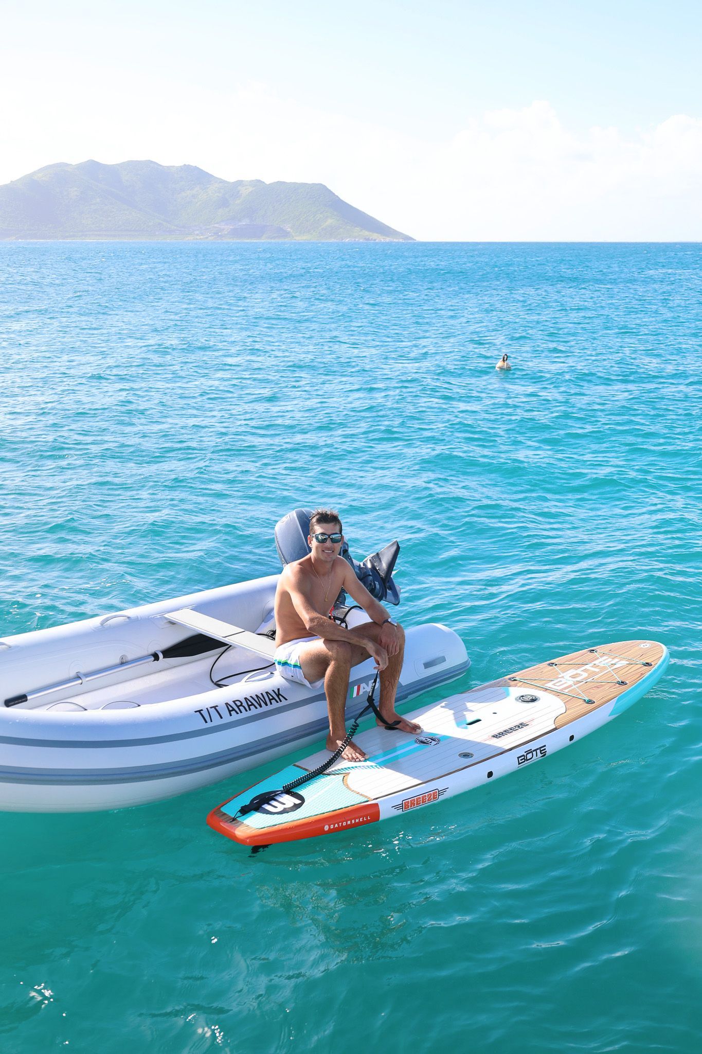 Guest enjoying paddleboard activity near Saint Martin, at Tintamarre beach