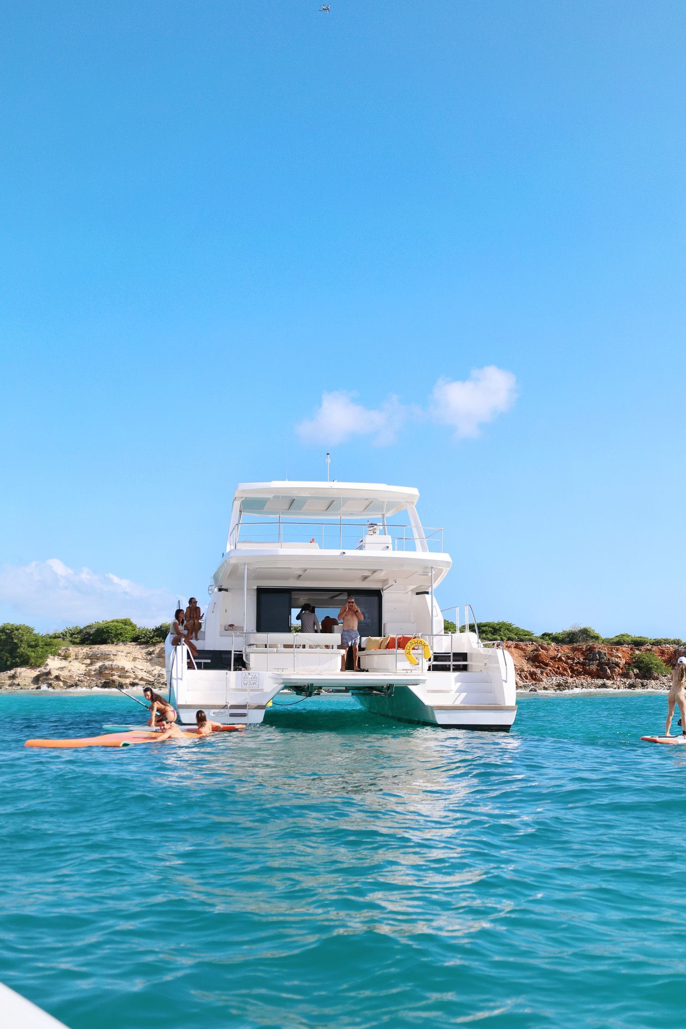 Guests relaxing on the deck of the Leopard 53 Power Catamaran by Arawak Charters at Tintamarre Island near Saint Martin.