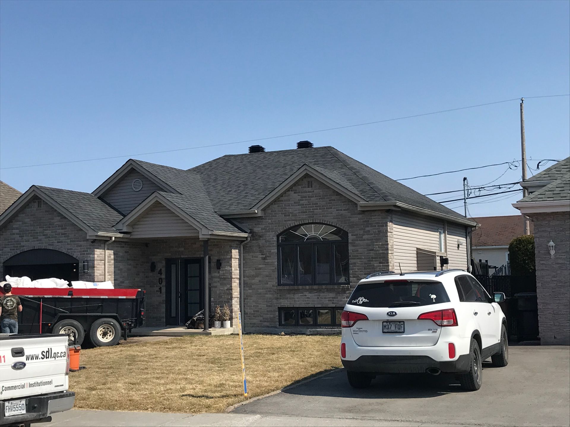 The roof of a house with a blue sky in the background