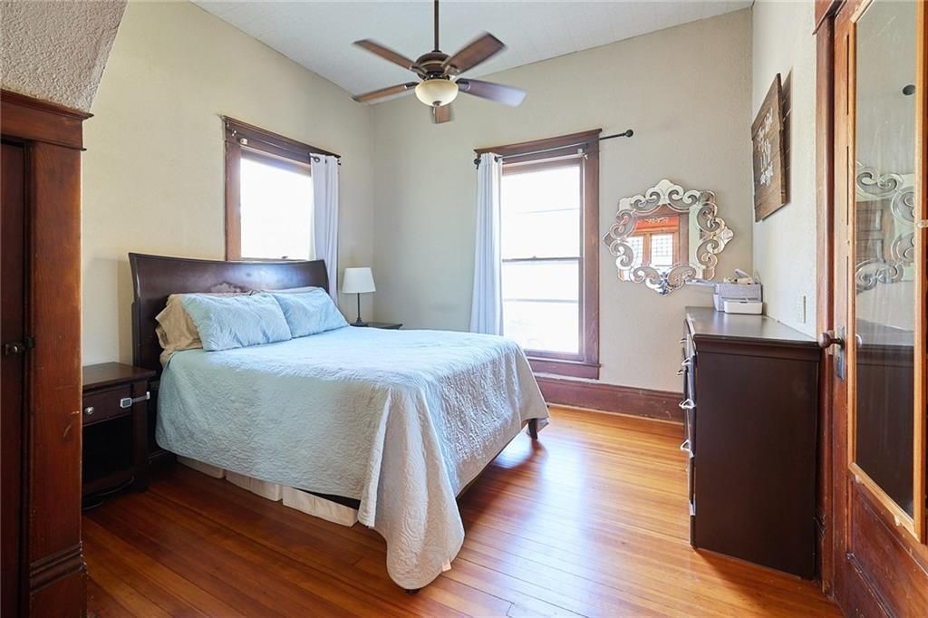 A large bed with wooden cabinet