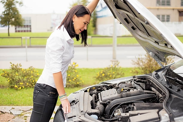A person looking at the engine of a car | Cheap Car Insurance Franklin WI | The Insurance Office