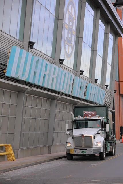 Truck parked outside Warrior Ice Arena, sign in blue and white. Bruins logo visible.