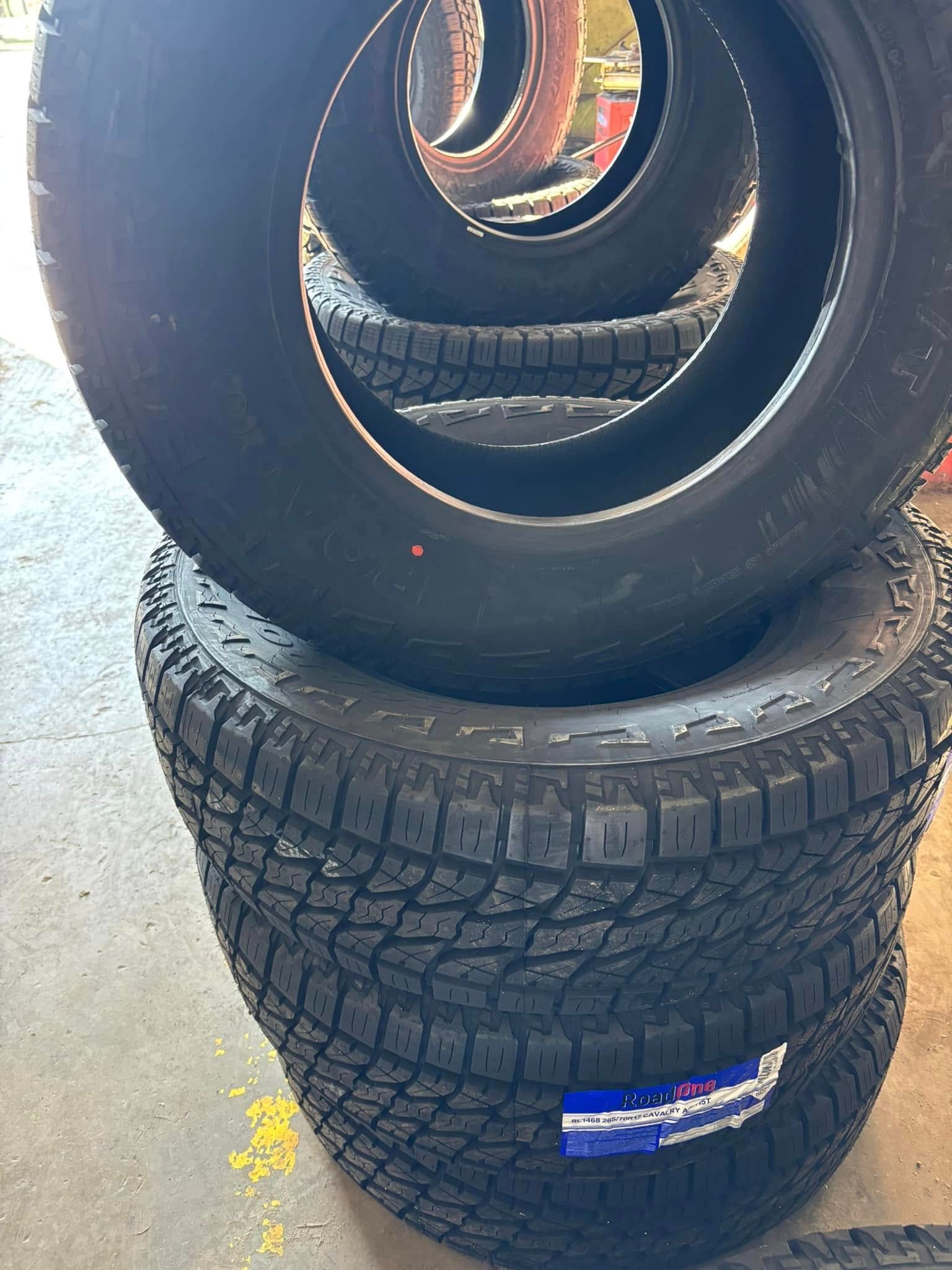 A stack of tires sitting on top of each other on the ground.