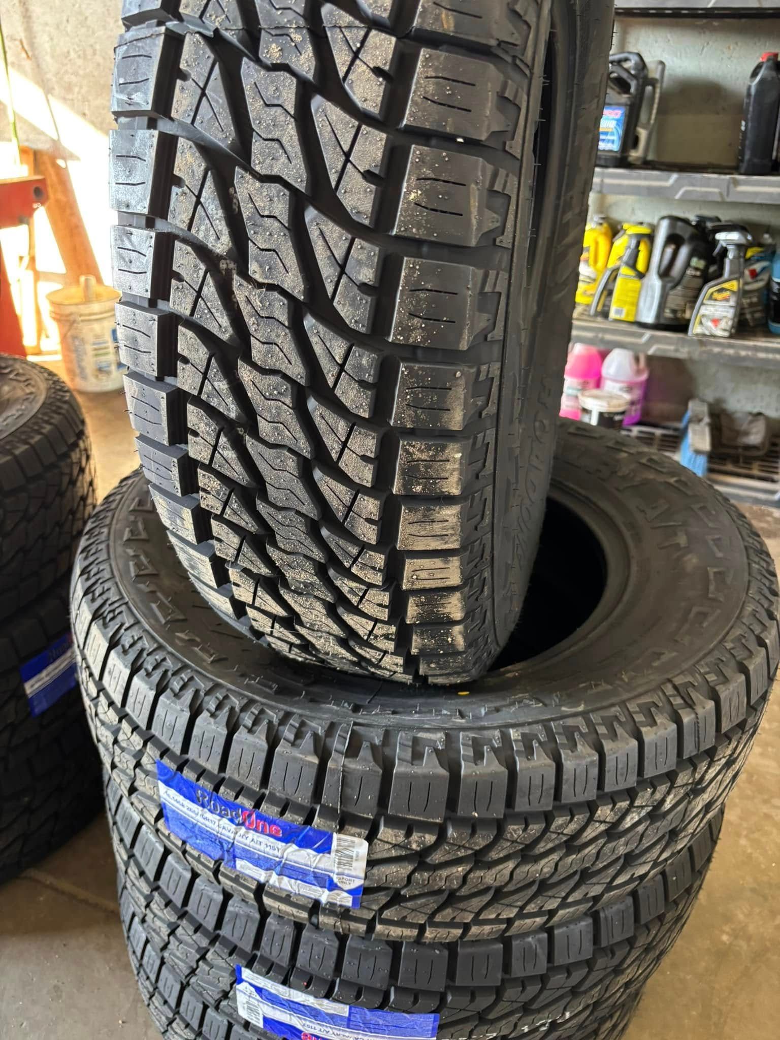 A stack of tires sitting on top of each other in a garage.