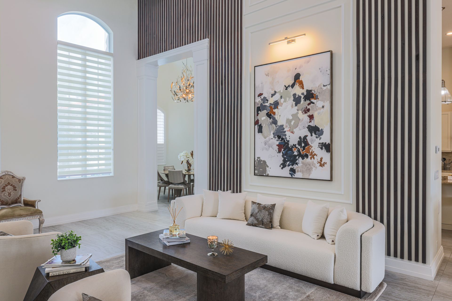 Luxurious living room with modern furniture and abstract art.