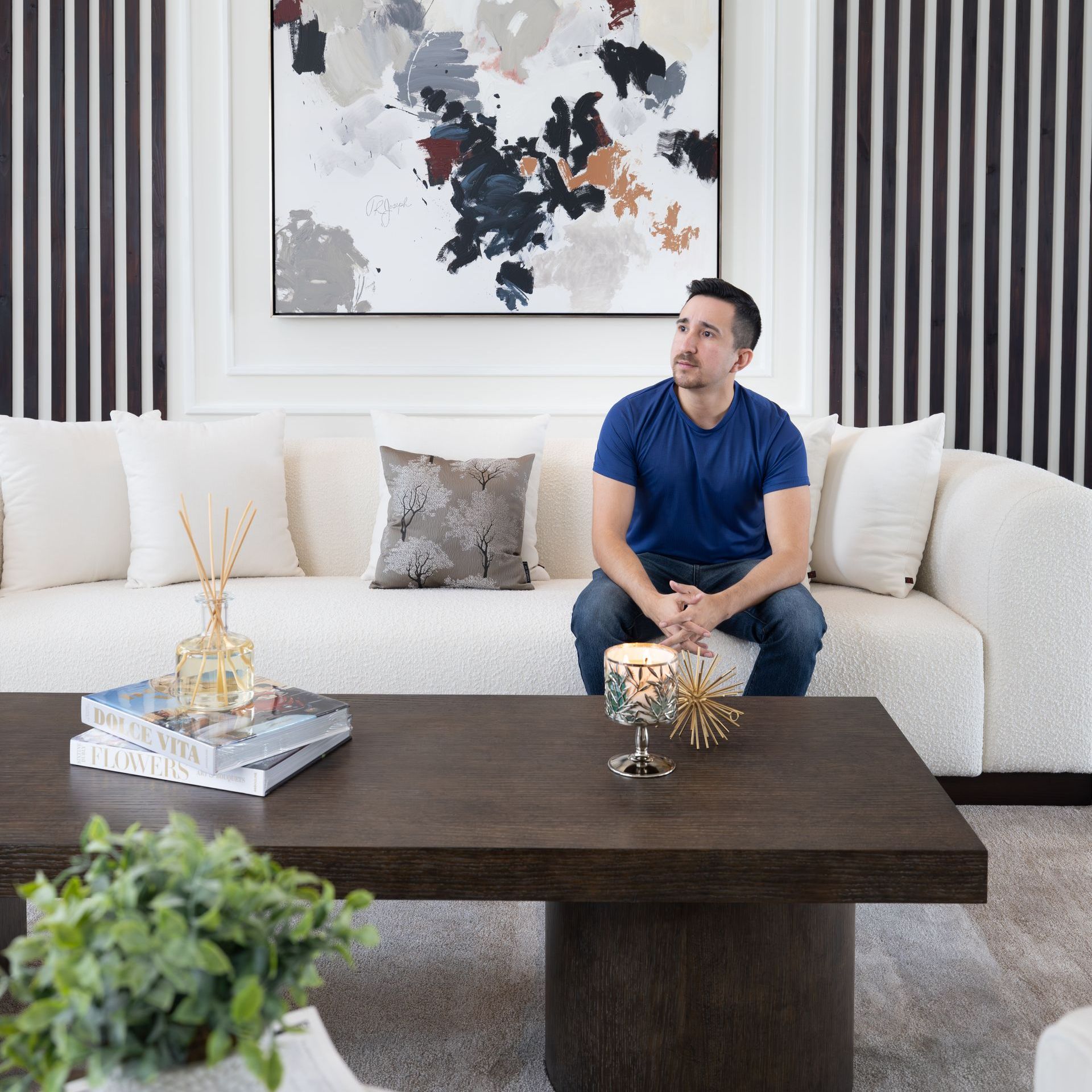 A black and white photo of a bathroom with a black bathtub and a walk in shower.