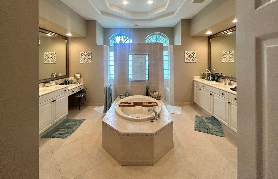 A bathroom with a large bathtub and two sinks