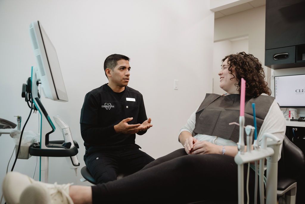 Dentist talking to patient in dental office.