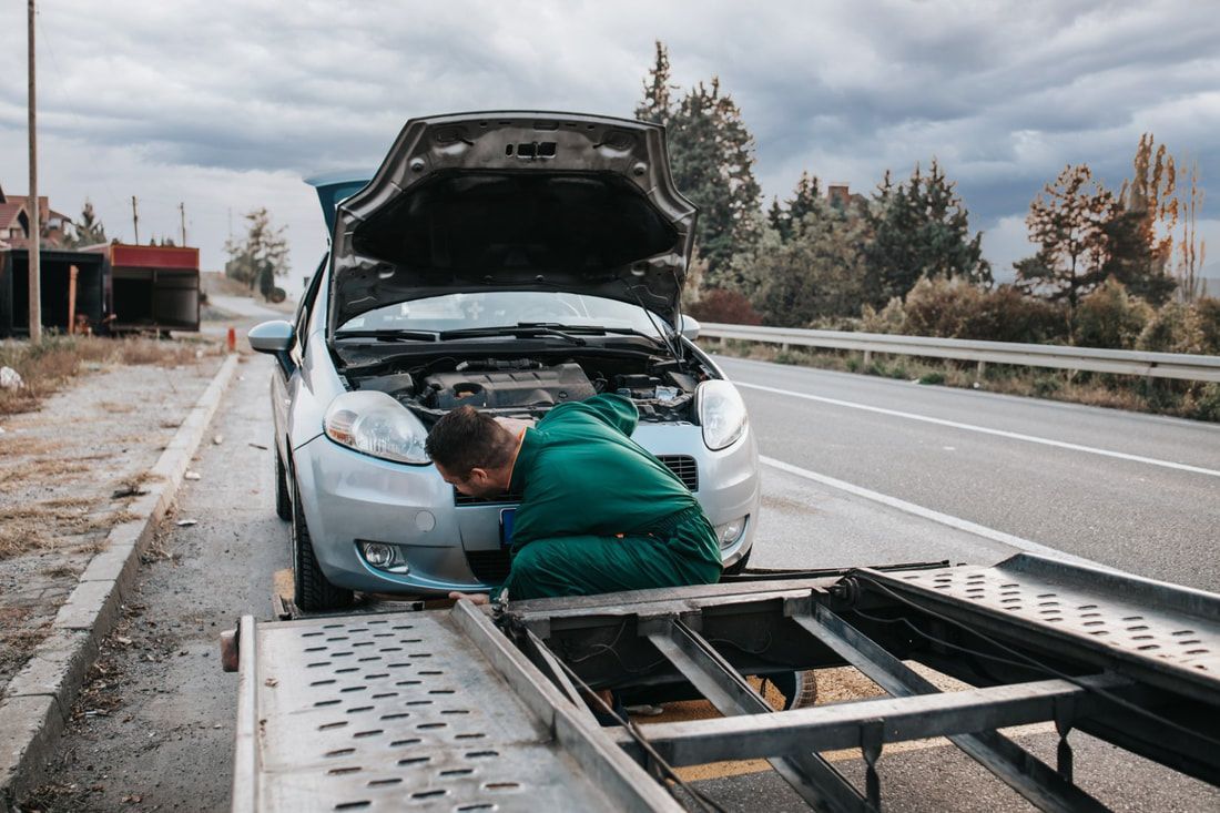 Technician preparing car for towing