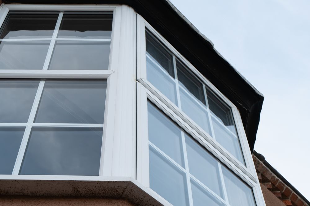 A white bay window on the side of a building