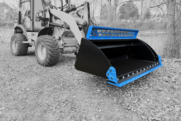 A bobcat skid steer is parked on a dirt road.