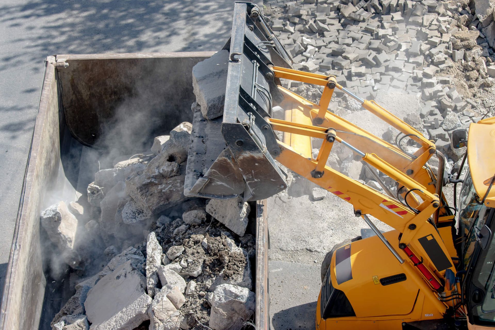 A person is using a hammer to break concrete.
