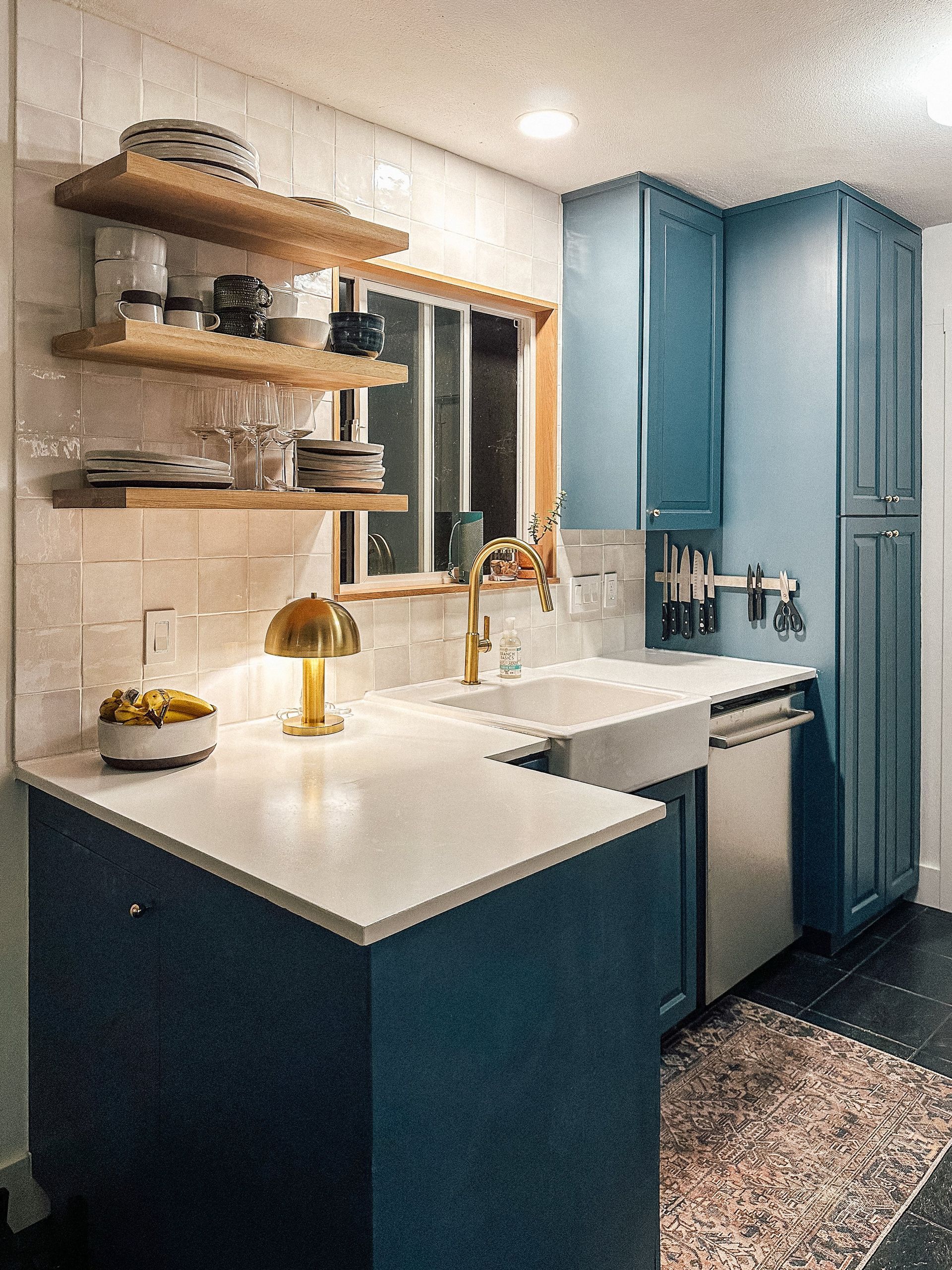 A kitchen with a large concrete countertop with a sink on it.