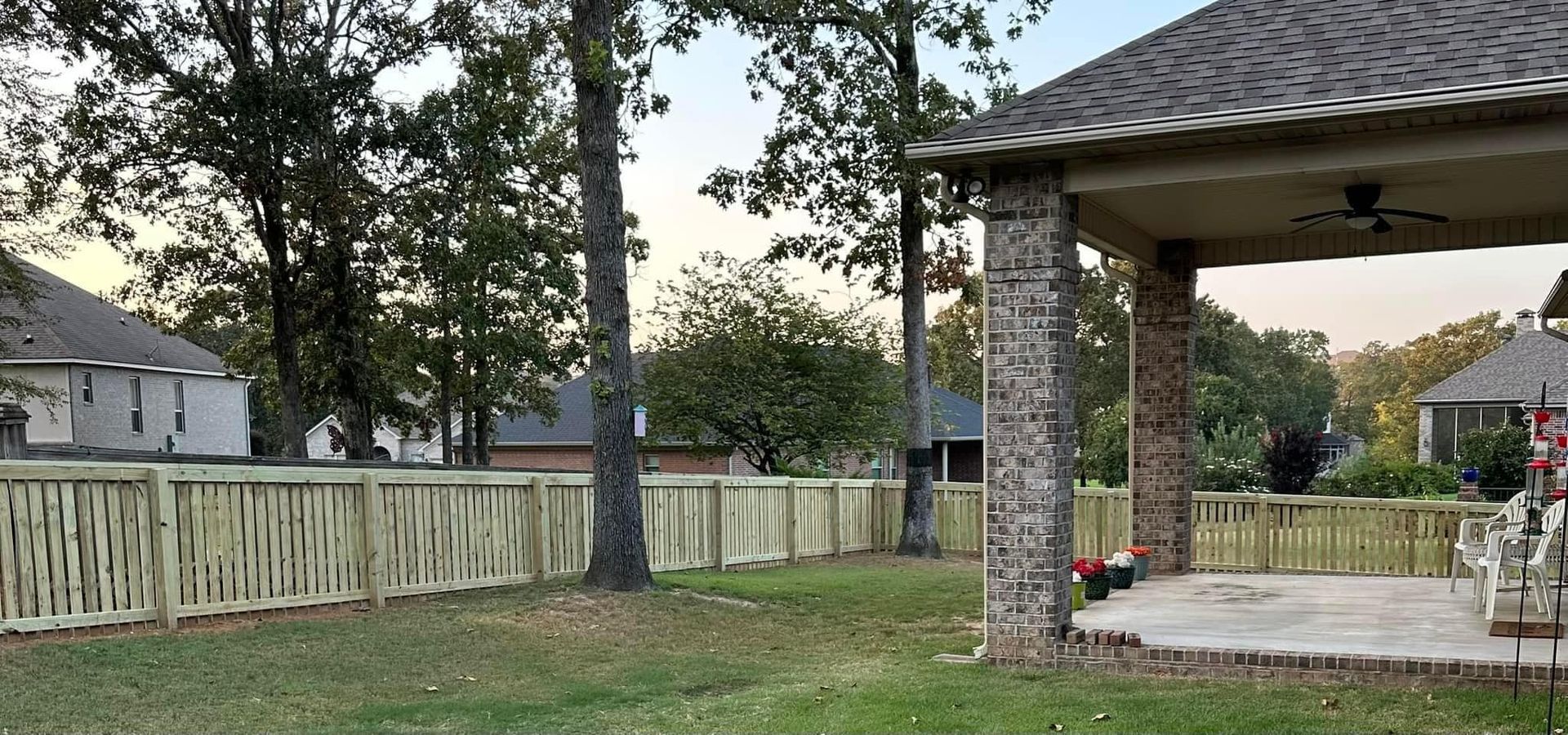 A backyard with a wooden fence and a gazebo in little rock, ar