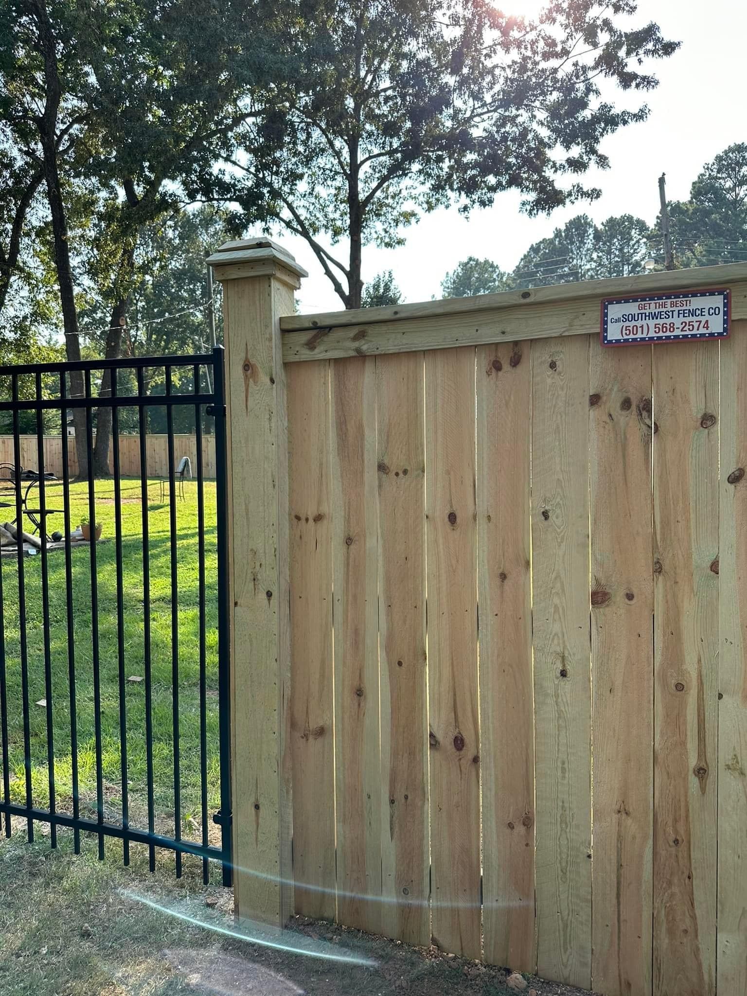 A wooden fence with a sign on it that says