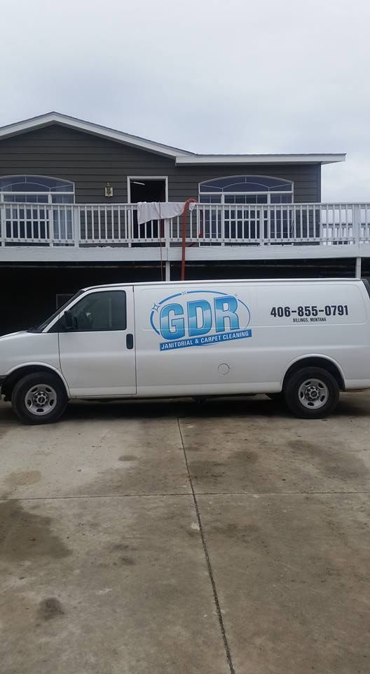 A white van is parked in front of a house.