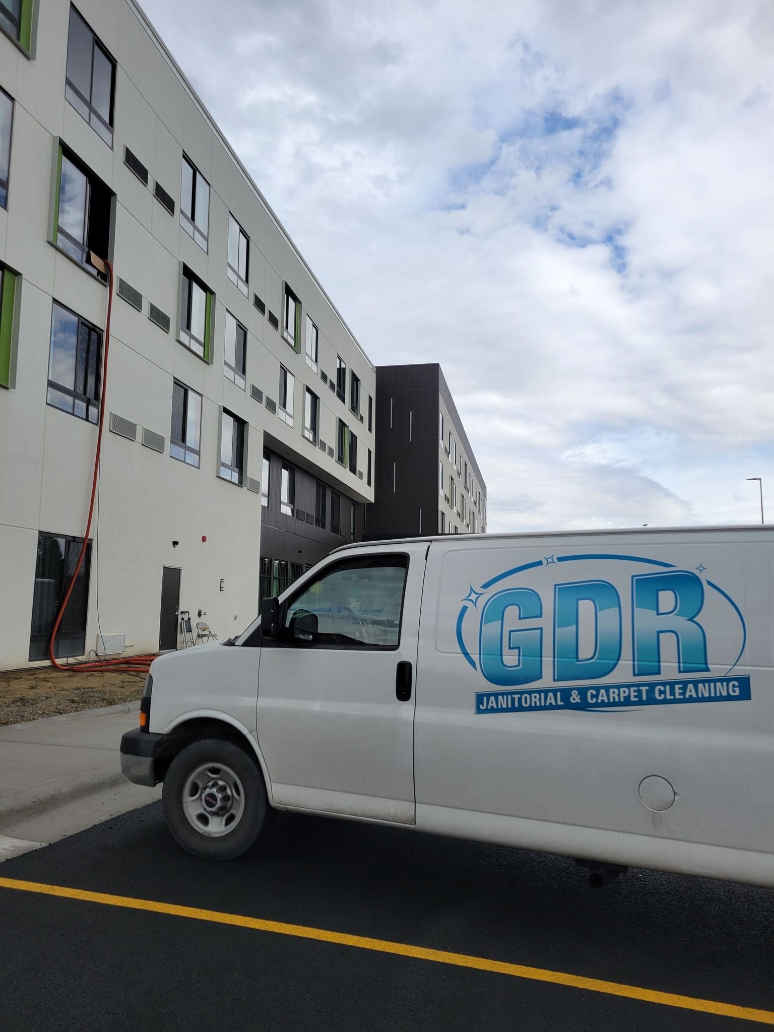 A gdr van is parked in front of a building