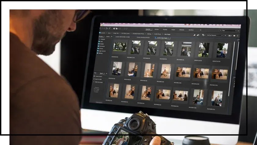 A man is looking at pictures on a computer screen.